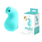 A small, turquoise, teardrop-shaped personal massager with silky-smooth silicone and control buttons on its surface is placed next to its packaging. The box features a matching turquoise and white color scheme and displays the brand name "VeDO" along with the product name "VeDO Suki - Turquoise Air Suction Clit Stimulator," plus additional product details.